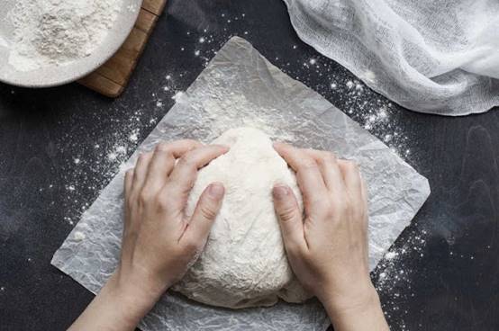 One image with people, dough, powder, masa cake Automatically generated descriptions